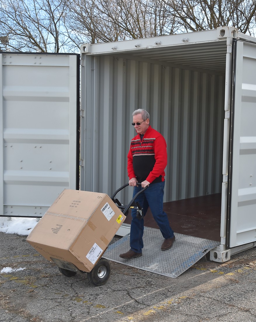 Photo of elderly pushing a delivery cart